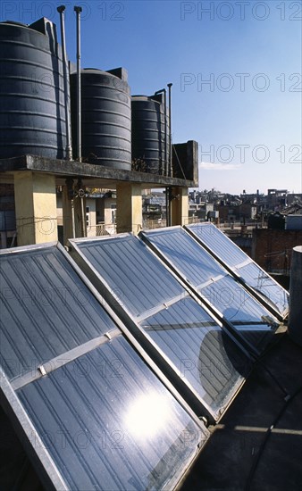 NEPAL, Kathmandu, Locally produced solar water heaters on rooftops with black hot water reservoirs.