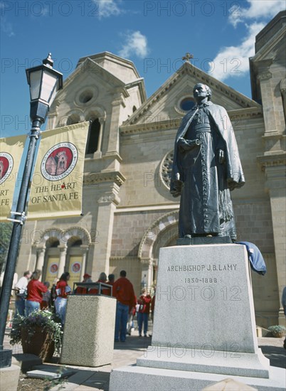 USA, New Mexico, Santa Fe, St Francis Cathedral with staue of J B Lamy in the foreground