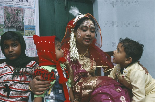 INDIA, West Bengal, Wedding, Hindu bride with children.