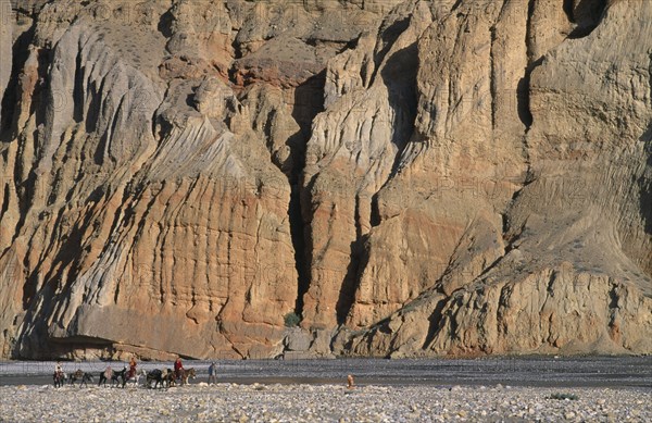 NEPAL, Mustang, High ranking Tibetan lama and Monks travelling across landscape by sheer cliffs to visit the Kingdom or Chhuksang