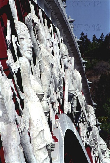 SOUTH KOREA, Cheju do Island, Peace Bridge. Detail of white carved figures adorning the side of the footbridge
