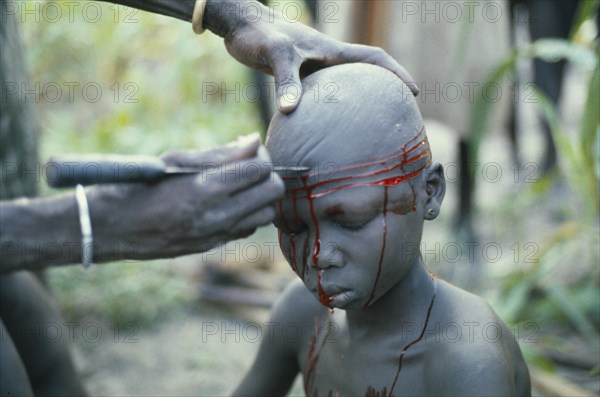 SUDAN, Scarification, "Dinka initiation into manhood.  Scarring ceremony in which each boy has six horizontal lines cut into his forehead, any sign of weakness brings dishonour.  "