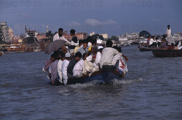 BANGLADESH, Dhaka, Overloaded country boat crossing the Buriganga River