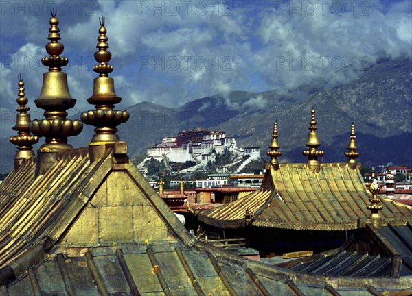 CHINA, Tibet, Lhasa, View from Jokhang Temple golden rooftops toward The Potala Palace in the distance