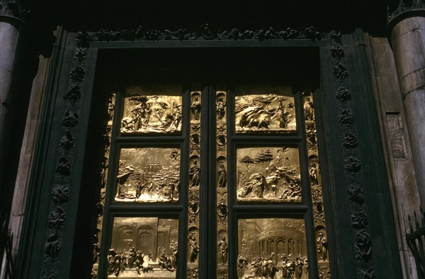 ITALY, Tuscany , Florence, Close up of black wooden Baptistry door of the Duomo with pannels of carved gold depicting stories from the Old Testament