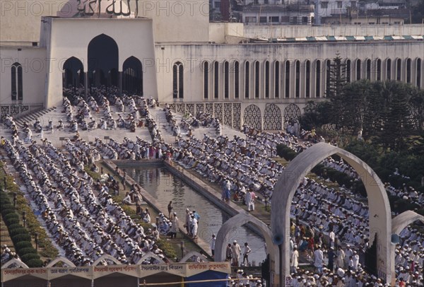 BANGLADESH, Dhaka, Muslim worshippers kneeling in prayer in courtyard of mosque.