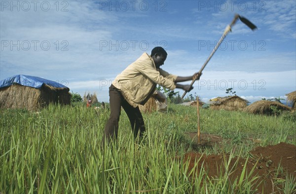 TANZANIA, , Heru Oshinga refugee camp. Burundian Hutu digging a waste pit