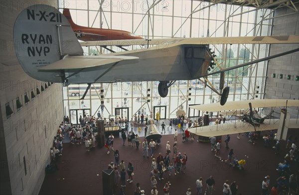 USA, Washington State, Washington DC, National Air and Space Museum.  Charles Lindberghs plane the Spirit of Saint Louis suspended inside the museum over visiting crowds.