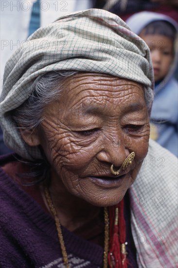 NEPAL, East, Dhankuta Region, Elderly Limbuni tribeswoman wearing traditional gold Limbu nose jewellery