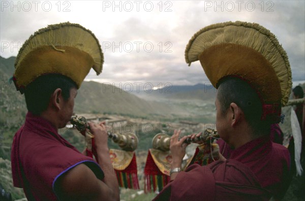 CHINA, Tibet, Drepung Monastery, Two monks blowing spiritual horns