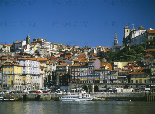 PORTUGAL, Porto, Oporto, City view from the River Douro toward the Ribeira District with Clerigos Tower in the distance