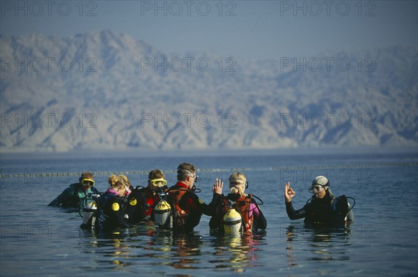 ISRAEL, Hadarom, Elat, Diving class giving the okay signal at Coral Beach underwater Nature Reserve