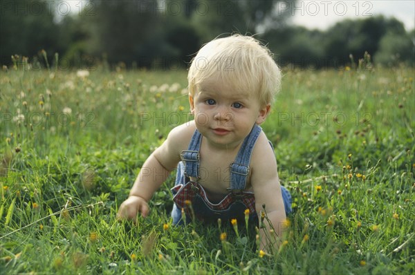CHILDREN, Babies, One year old baby boy crawling on the grass