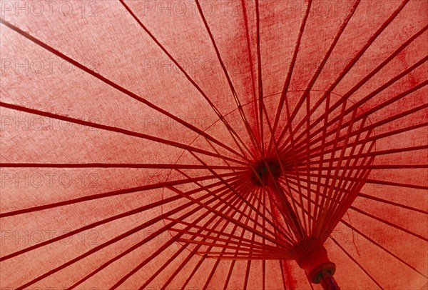 THAILAND, Baw Sang, Inside view of red painted umbrella in village outside Chiang Mai which specialises in their production.