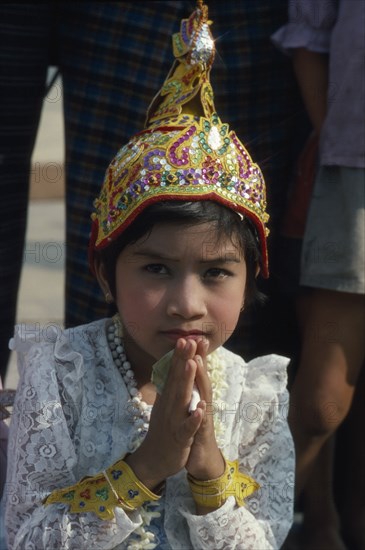 MYANMAR, Yangon, Shwedagon Pagoda.  Young girl in novice monk initiation ceremony