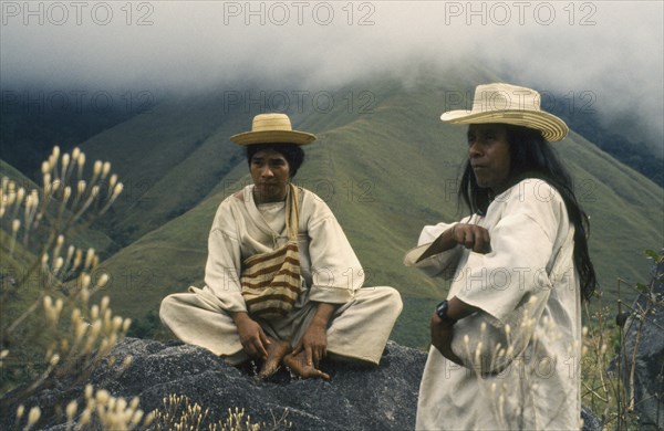 COLOMBIA, People, Kogi, Ramonil and Juancho two Kogi priests from the Sierra de Santa Marta against a backdrop of misty green hills