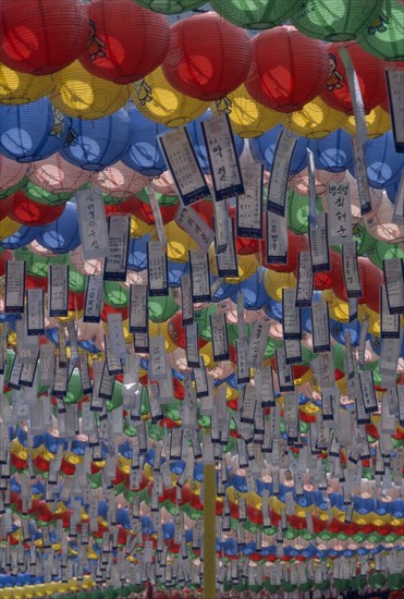 SOUTH KOREA, Seoul, Jogyesa Temple.  Canopy of paper lanterns and prayer streamers hung to celebrate the birthday of Buddha.