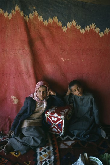 Qatar, Nomads, Bedouin children inside tent.