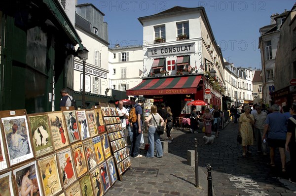 FRANCE, Ile de France, Paris, Posters for sale on a pedestrianized cobbled street