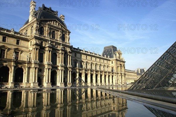 FRANCE, Ile de France, Paris, The Musee du Louvre facade with section of the Glass Pyramid in front