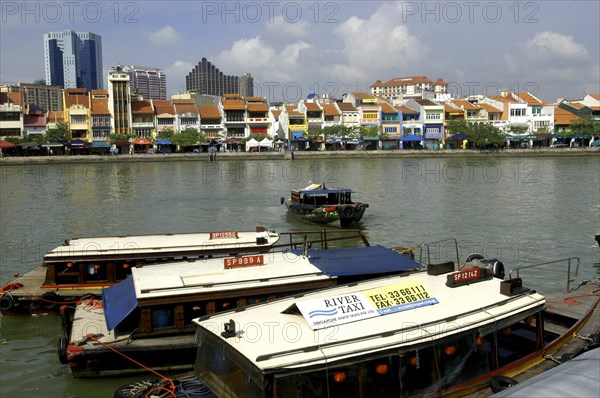 SINGAPORE, General, Three moored boats on Singapore River with city architecture on the opposite bank