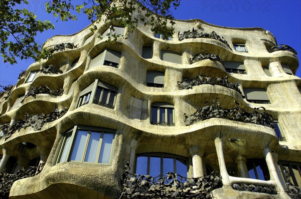 SPAIN, Catalonia, Barcelona, Angled view looking up at Gaudi apartment building Casa Mila