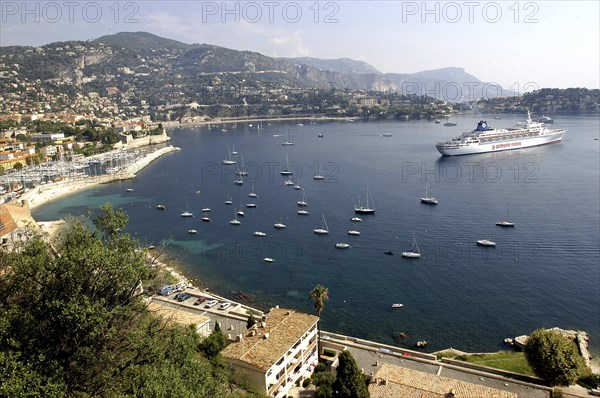 FRANCE, Cote d Azur, View over bay between Nice and Monte Carlo with moored Cruise ship and smaller boats