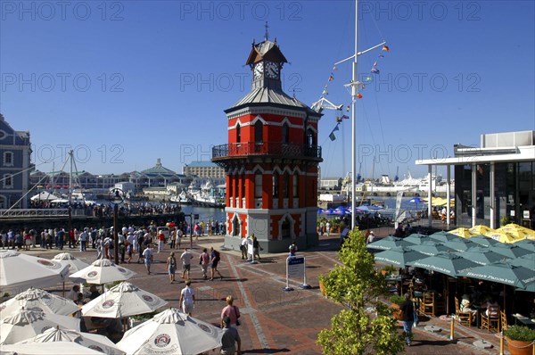 SOUTH AFRICA, Western Cape, Cape Town, View over busy waterfront area toward the brightly coloured clock tower