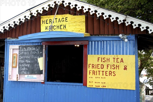 WEST INDIES, Cayman Islands, Fish House with menu board outside small opening