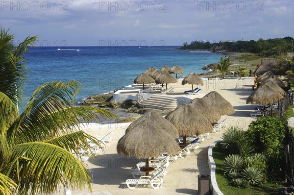 MEXICO, Quintana Roo, Cozumel Island, View over sandy beach with thatched umbrellas