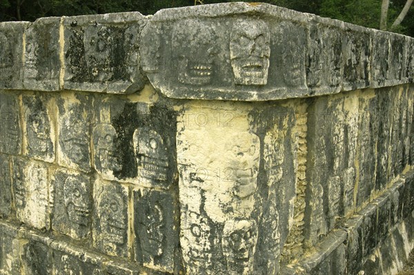 MEXICO, Yucatan, Chichen Itza, Corner detail of Mayan carved stone showing skulls