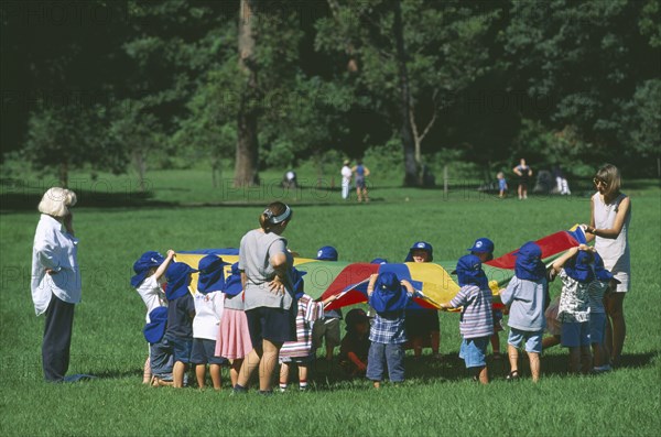 AUSTRALIA, New South Wales, Sydney, Balmoral.  School children in sunhats playing game outside supervised by teachers in North Shore city suburb.