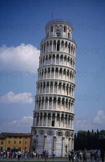 ITALY, Tuscany, Pisa, The Leaning Tower with tourists gathered at the base