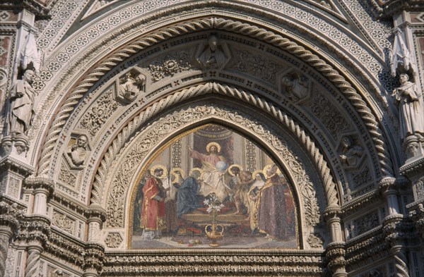ITALY, Tuscany, Florence, View of painting and carving above doors at Duomo Cathedral.