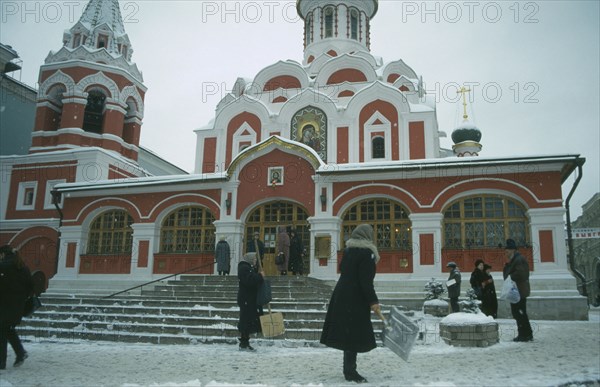 RUSSIA, Moscow, Red Square.  Pedestrians clearing a path through the snow.