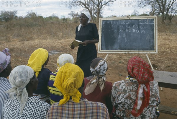 KENYA, Kakimakoi, Adult literacy class in outdoor classroom.