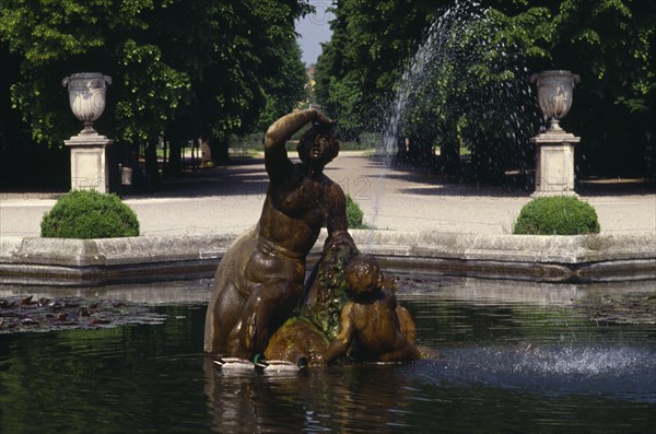 AUSTRIA, Vienna, Schonbrunn Palace Gardens.  Statue and fountain in pool.