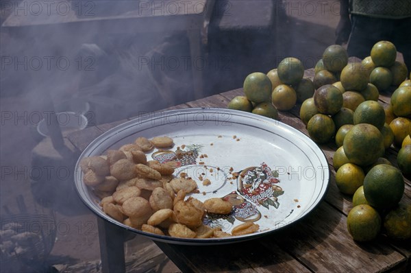 NIGERIA, Jos, Deep fried pea cakes and green oranges.