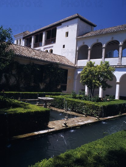 SPAIN, Andalucia, Granada, The Alhambra. Generalife Gardens. Jardin de Sultana with fountains and Generalife Palace or Summer Palace