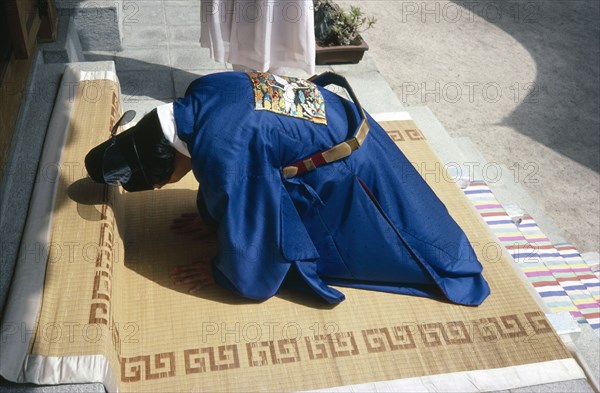 SOUTH KOREA, People, Buddhist wedding.  Bridegroom bows in religious submission.