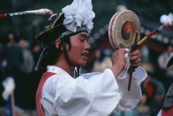 SOUTH KOREA, Arts, Farmers Dance.  Dancer performing fast Chwado-Ko with ribbons on head-dress creating patterns in the air