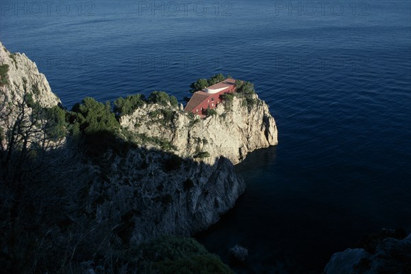 ITALY, Campania, Capri, Cap Massulo. Villa Malaparte. Red building built at the end of a cliff surrounded by the Mediterranean sea. Constructed by the architect Adalberto Libera for the writer and journalist Curzio Suckert who named it  ‘house like me’ in 1938. Casa