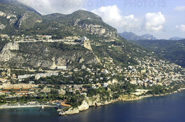 MONACO, Cote d Azur, Monte Carlo, Aerial view from the sea toward the hillside coastal city and coastline