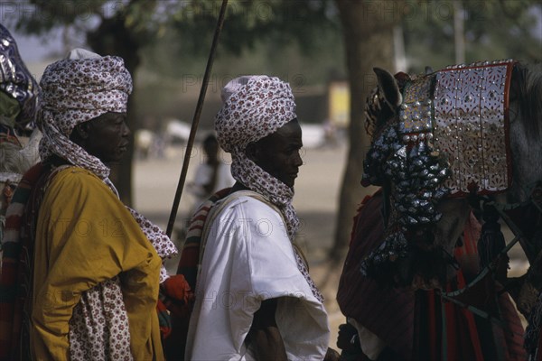 NIGERIA, Katsina, Salah Day. The Emirs entourage including horse wearing heavily decorated bridle.