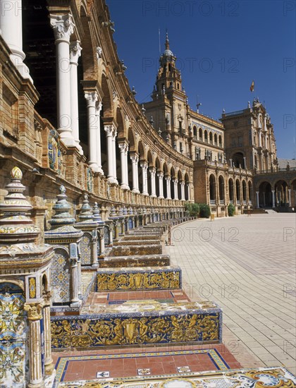 SPAIN, Andalucia, Seville, Plaza de Espana. View along colonnade and seats toward the Central Pavilion