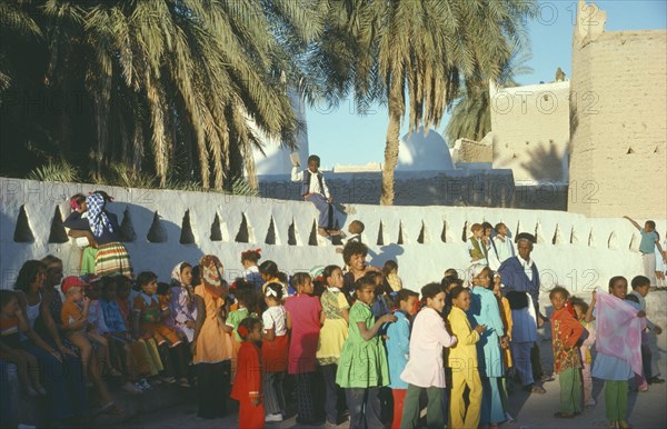 LIBYA, Gadames, Mixed crowd in street.