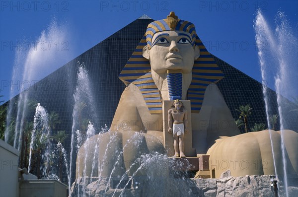 USA, Nevada, Las Vegas, The Luxor Hotel exterior with entrance through life size replica of the Sphinx with fountains in foreground.