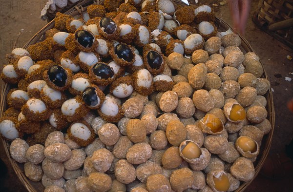 CHINA, Yunnan, Kunming, Covered food market  with baskets filled with thousand year old eggs.