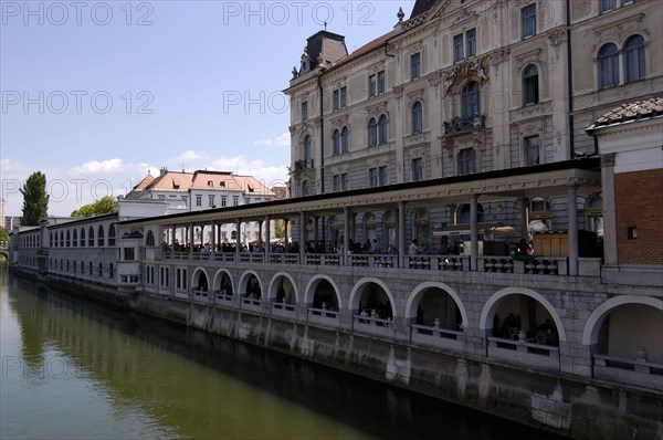 SLOVENIA, Ljubljana, River Ljubljanica. View along embankment and colonnade designed by Joze Plecnik