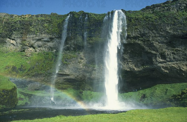 ICELAND, Near Skogar , Waterfall cascading over cliff on the south coast road